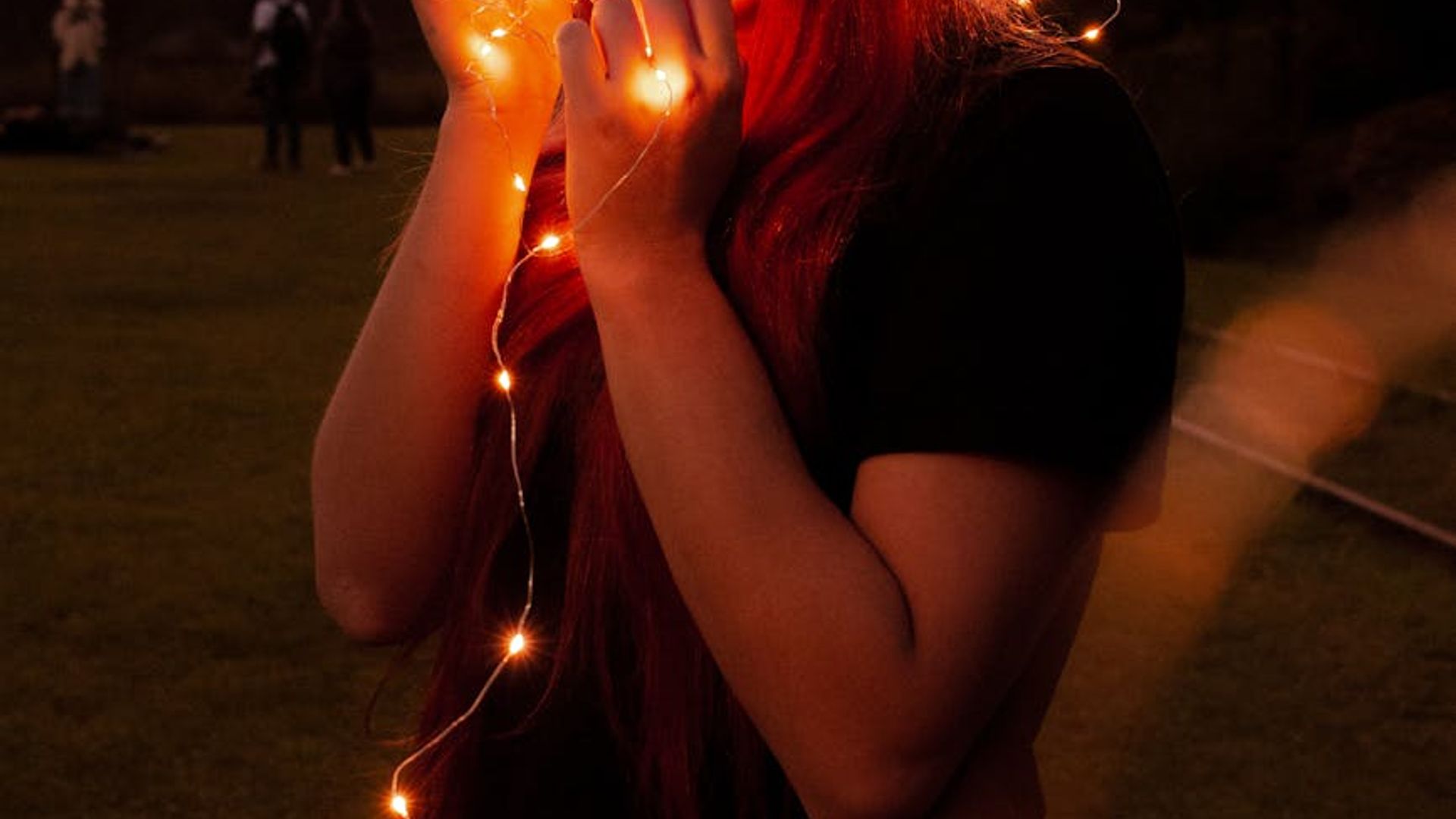 Woman silhouette in a dynamic cardio pose against a dark background with violet light glow.